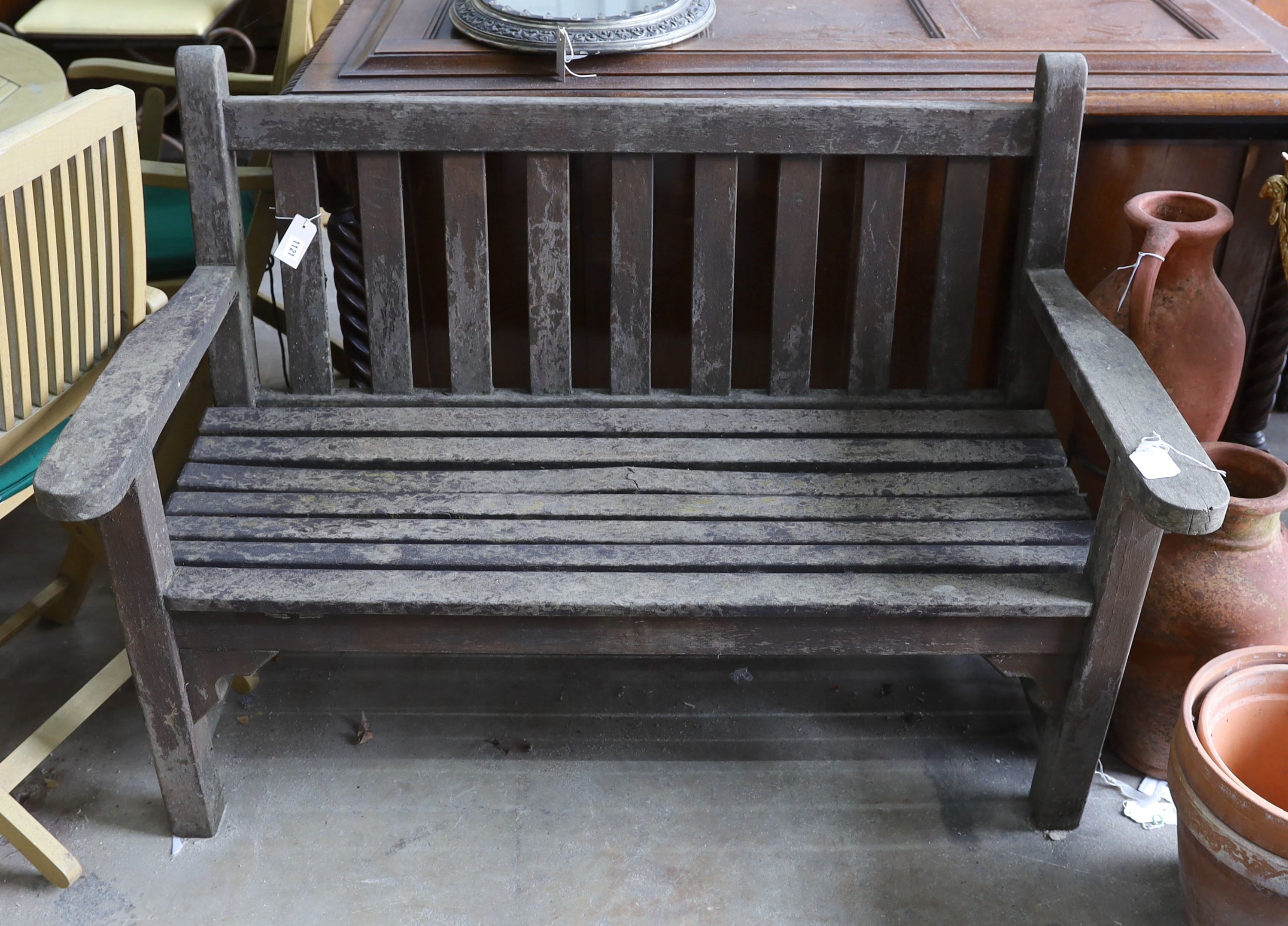 A weathered teak slatted garden bench, length 128cm, depth 62cm, height 91cm